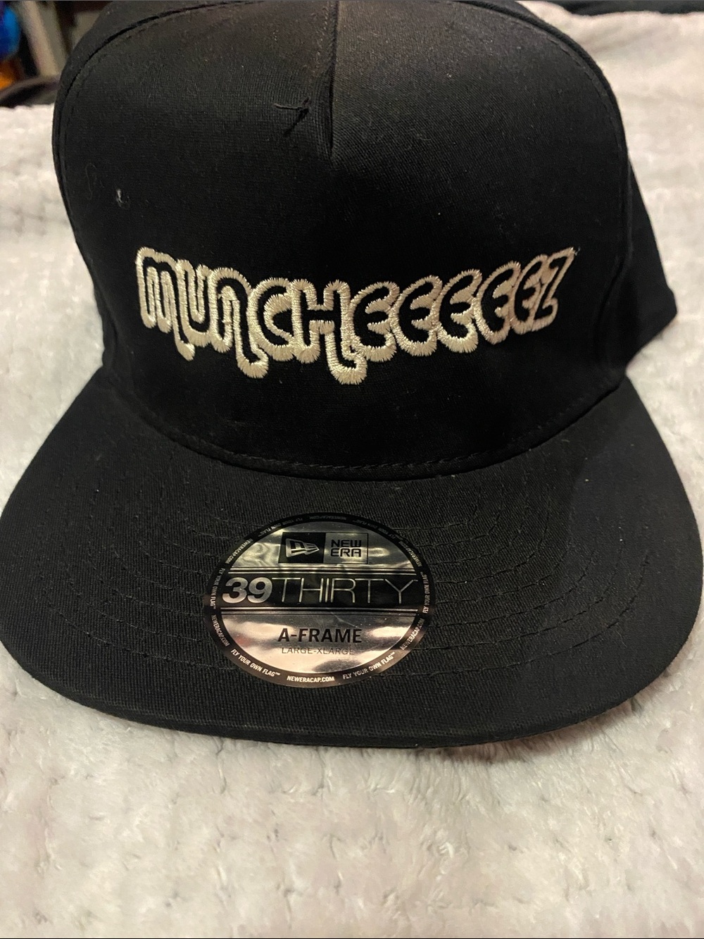 New Era Black Cap with White 'MUNCHEEEEEZ' Embroidery